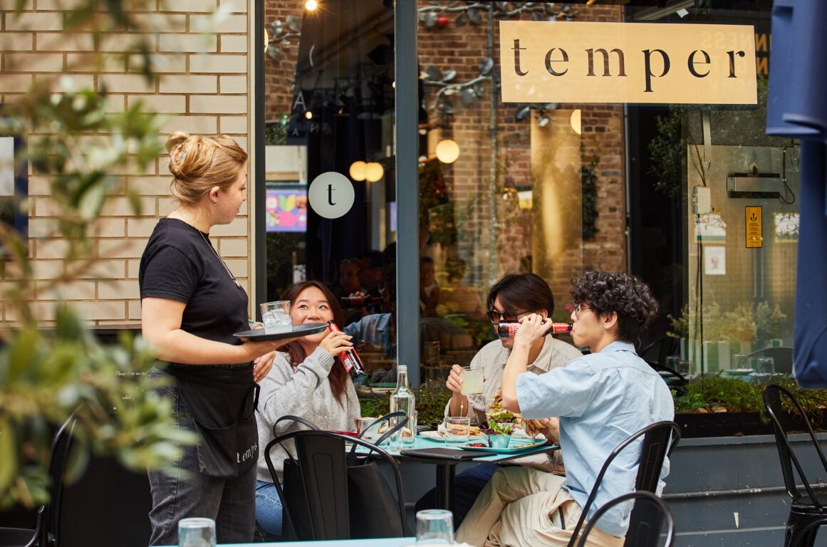 a group of friends eating lunch outside a restaurant