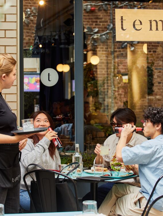 a group of friends eating lunch outside a restaurant